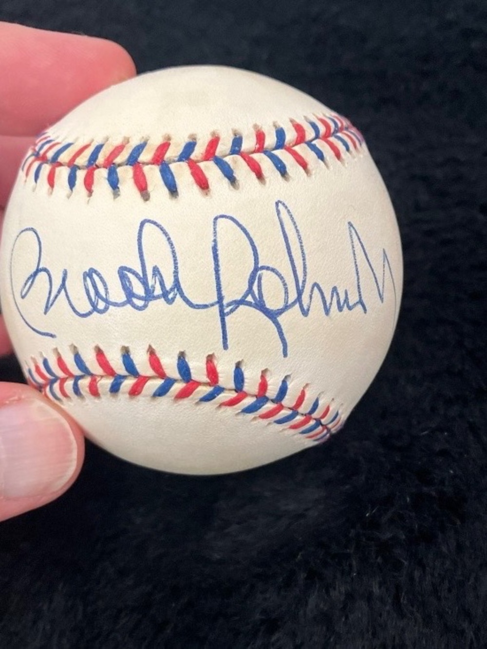 Autographed White Baseball with Red & Blue Stitching